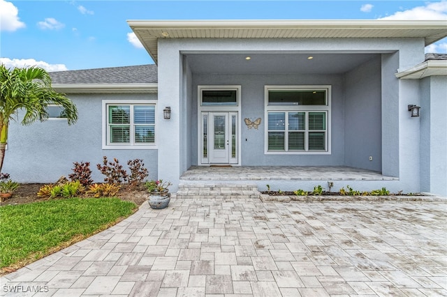 2228 SW 15th Ave, Cape Coral, FL 33991 - view of exterior entry featuring stucco siding and covered porch