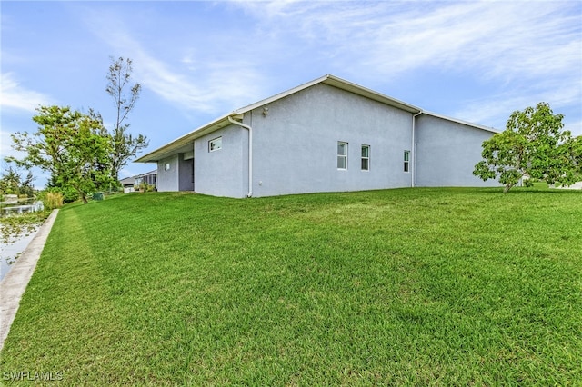 2228 SW 15th Ave, Cape Coral, FL 33991 - view of side of home with stucco siding and a yard