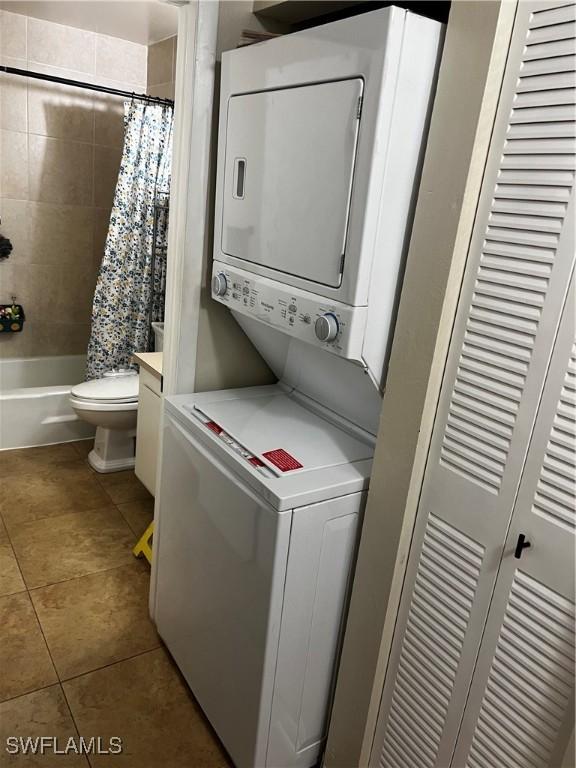 3303 Royal Canadian Trce Unit 4, Fort Myers, FL 33907 - laundry area with stacked washing machine and dryer and tile patterned flooring