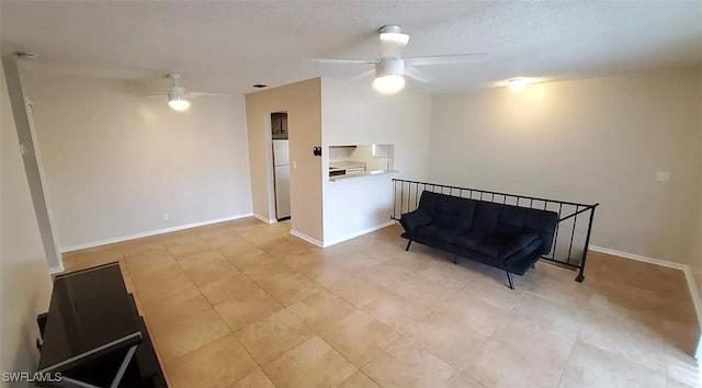 3303 Royal Canadian Trce Unit 4, Fort Myers, FL 33907 - sitting room with ceiling fan, baseboards, and a textured ceiling