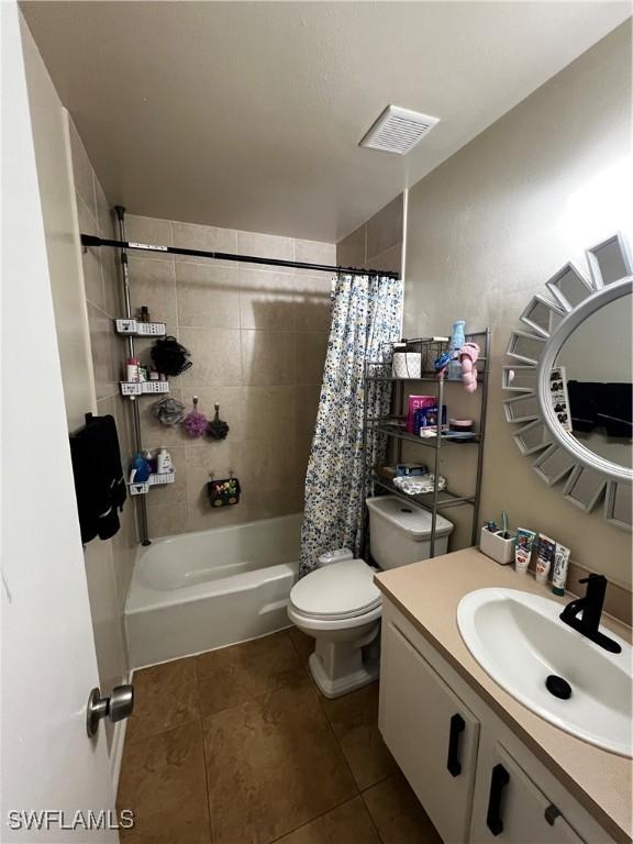 3303 Royal Canadian Trce Unit 4, Fort Myers, FL 33907 - full bath featuring vanity, tile patterned floors, toilet, and shower / bath combination with curtain