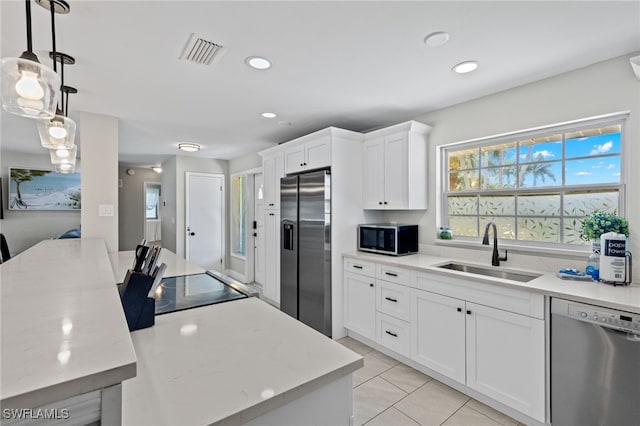 3117 SE 18th Ave, Cape Coral, FL 33904 - kitchen with appliances with stainless steel finishes, a sink, white cabinets, recessed lighting, and light stone counters