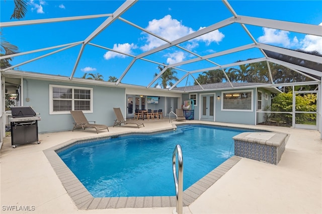 3117 SE 18th Ave, Cape Coral, FL 33904 - outdoor pool featuring area for grilling, a patio, french doors, and glass enclosure