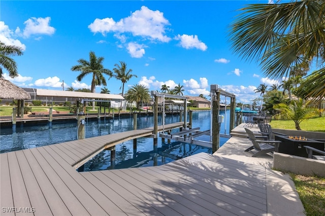 3117 SE 18th Ave, Cape Coral, FL 33904 - dock area with boat lift, a fire pit, and a water view
