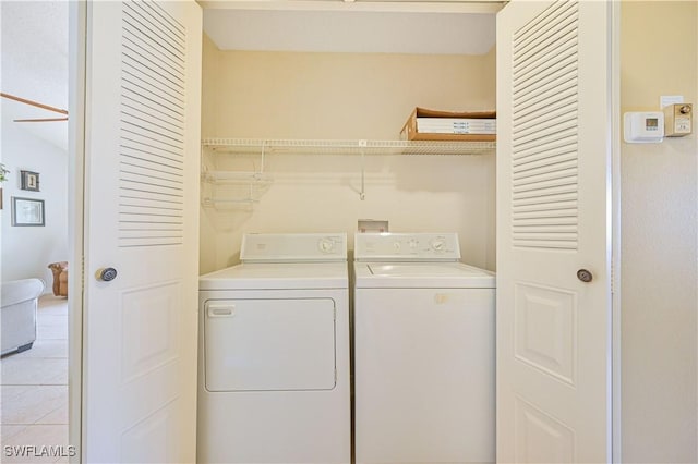 17458 Blueberry Hill Dr Unit F, Fort Myers, FL 33908 - laundry room featuring washing machine and clothes dryer and light tile patterned flooring