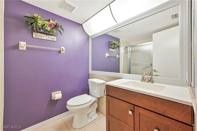 17458 Blueberry Hill Dr Unit F, Fort Myers, FL 33908 - bathroom with tile patterned floors, toilet, a shower stall, and vanity
