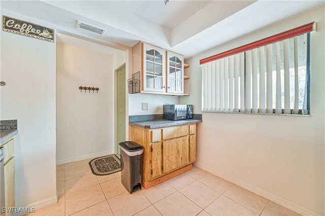 17458 Blueberry Hill Dr Unit F, Fort Myers, FL 33908 - kitchen with baseboards, glass insert cabinets, and plenty of natural light