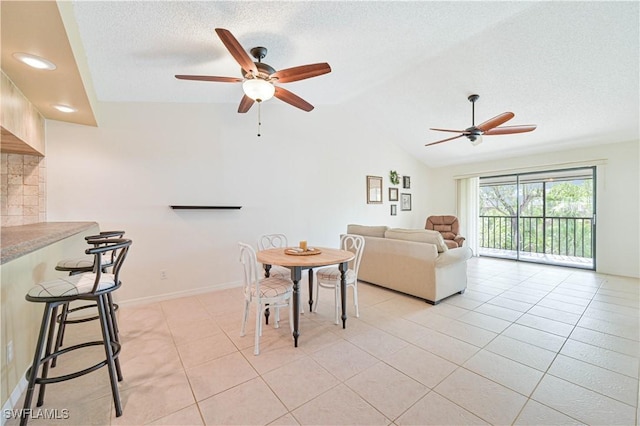 17458 Blueberry Hill Dr Unit F, Fort Myers, FL 33908 - living area with a ceiling fan, a textured ceiling, light tile patterned floors, and vaulted ceiling