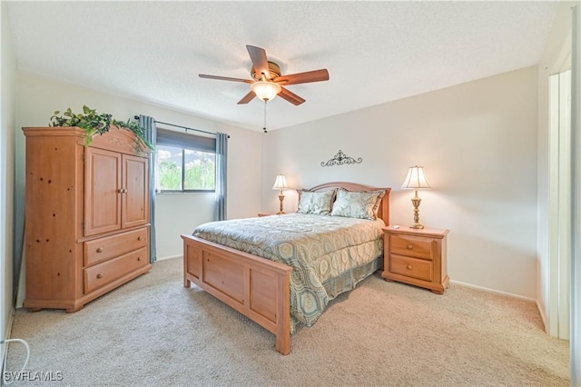 17458 Blueberry Hill Dr Unit F, Fort Myers, FL 33908 - bedroom with light carpet, baseboards, a ceiling fan, and a textured ceiling