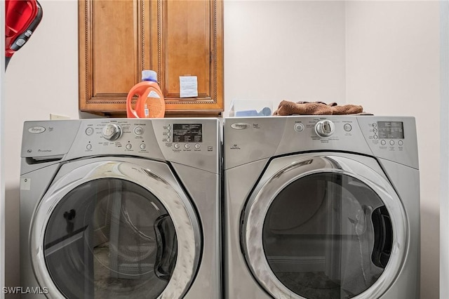 15657 Carriedale Ln, Fort Myers, FL 33912 - laundry room with washing machine and dryer and cabinet space