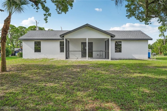 4906 5th St W, Lehigh Acres, FL 33971 - back of house featuring stucco siding, a lawn, and a sunroom