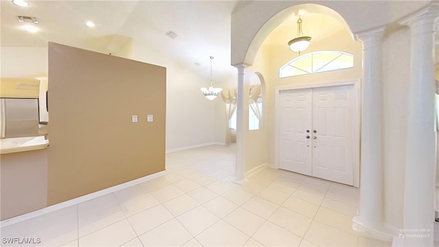1108 Lee Ave, Lehigh Acres, FL 33972 - foyer entrance featuring ornate columns, lofted ceiling, arched walkways, recessed lighting, and light tile patterned flooring