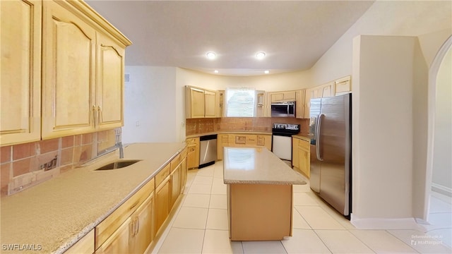 1108 Lee Ave, Lehigh Acres, FL 33972 - kitchen featuring appliances with stainless steel finishes, light brown cabinetry, a center island, tasteful backsplash, and recessed lighting