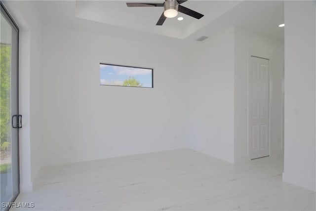 1254 Nimitz Blvd, Lehigh Acres, FL 33974 - unfurnished room with plenty of natural light, a ceiling fan, a tray ceiling, and recessed lighting
