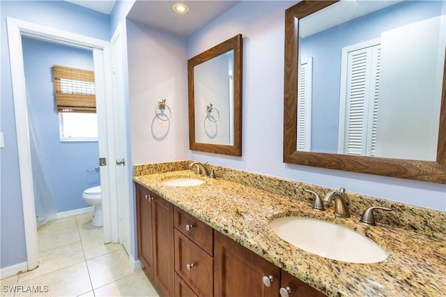 1644 N Hermitage Rd, Fort Myers, FL 33919 - full bath featuring toilet, double vanity, baseboards, tile patterned floors, and recessed lighting