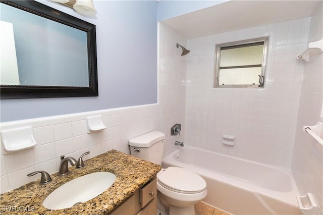 1644 N Hermitage Rd, Fort Myers, FL 33919 - full bathroom with tile walls, shower / bath combination, vanity, toilet, and wainscoting