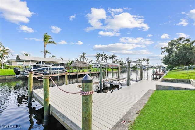 4969 Vincennes St, Cape Coral, FL 33904 - dock with boat lift, a water view, and a lawn