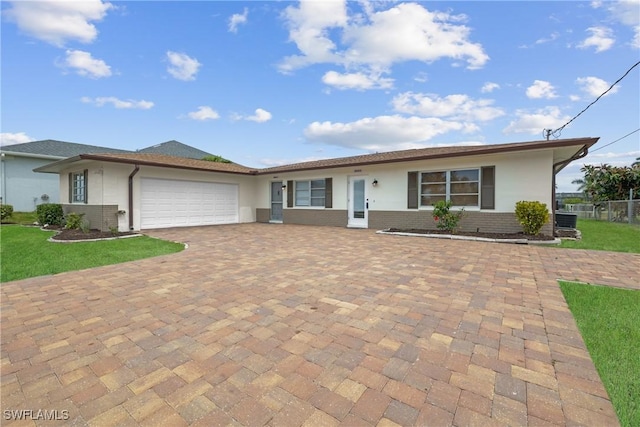 4969 Vincennes St, Cape Coral, FL 33904 - ranch-style house featuring stucco siding, an attached garage, central AC unit, driveway, and brick siding