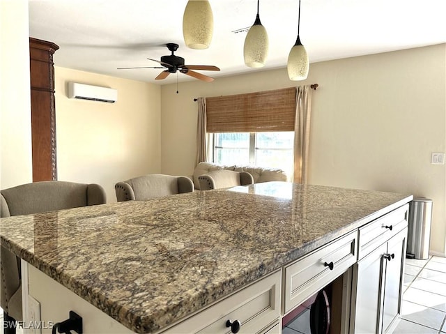 4969 Vincennes St, Cape Coral, FL 33904 - kitchen featuring a wall mounted air conditioner, ceiling fan, light tile patterned floors, and dark stone countertops