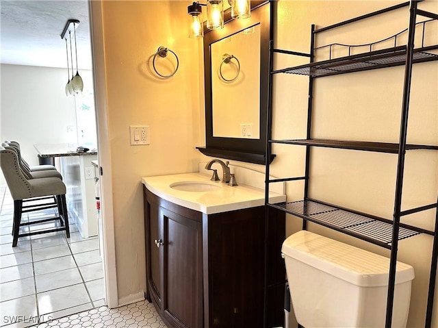 4969 Vincennes St, Cape Coral, FL 33904 - bathroom featuring vanity, toilet, baseboards, and tile patterned flooring