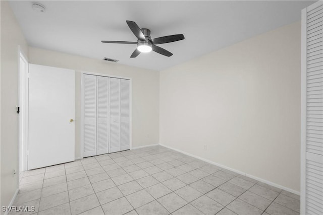 4969 Vincennes St, Cape Coral, FL 33904 - unfurnished bedroom featuring a closet, baseboards, a ceiling fan, and light tile patterned flooring