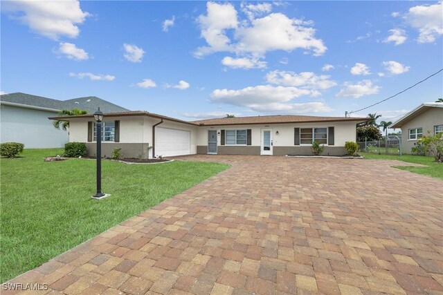 4969 Vincennes St, Cape Coral, FL 33904 - ranch-style home featuring driveway, a garage, and stucco siding