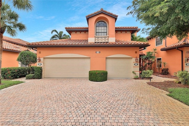 5795 Grande Reserve Way Unit 1001, Naples, FL 34110 - mediterranean / spanish-style house with stucco siding, driveway, and a tiled roof