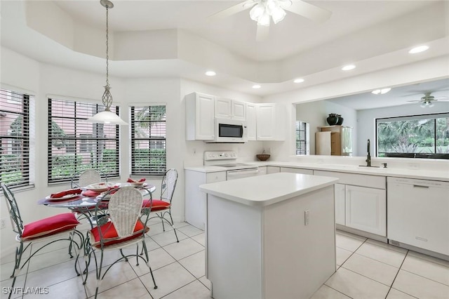 5795 Grande Reserve Way Unit 1001, Naples, FL 34110 - kitchen with white appliances, ceiling fan, a sink, a center island, and plenty of natural light