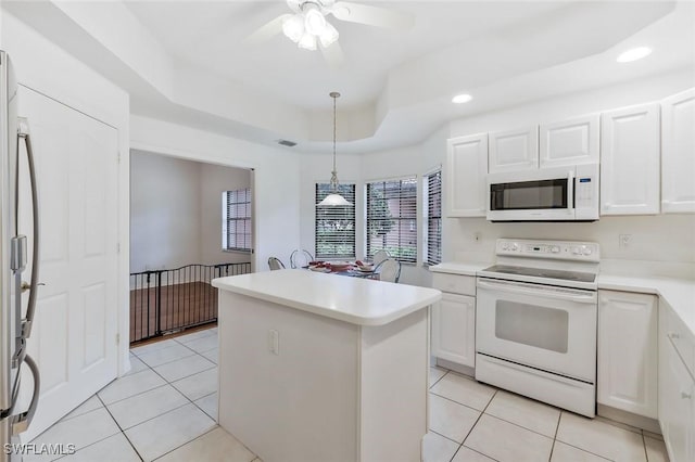 5795 Grande Reserve Way Unit 1001, Naples, FL 34110 - kitchen with white appliances, a raised ceiling, light tile patterned floors, a kitchen island, and recessed lighting