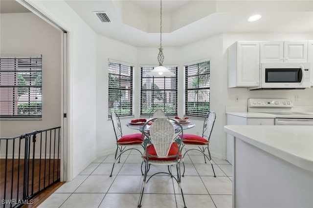 5795 Grande Reserve Way Unit 1001, Naples, FL 34110 - dining space with baseboards, light tile patterned floors, a tray ceiling, and recessed lighting