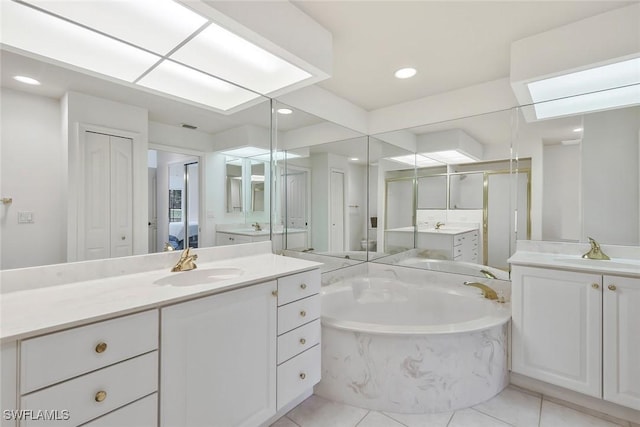 5795 Grande Reserve Way Unit 1001, Naples, FL 34110 - bathroom with a garden tub, two vanities, tile patterned flooring, a shower stall, and recessed lighting