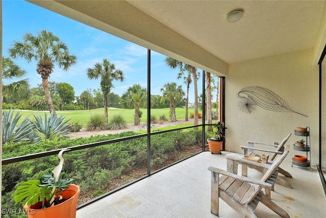5795 Grande Reserve Way Unit 1001, Naples, FL 34110 - sunroom / solarium with golf course view and a textured wall