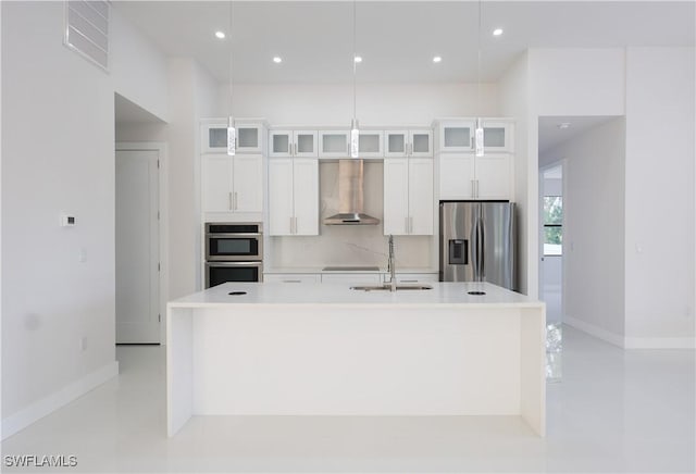 2219 Surfside Blvd, Cape Coral, FL 33991 - kitchen featuring wall chimney exhaust hood, stainless steel appliances, a sink, baseboards, and a kitchen island with sink