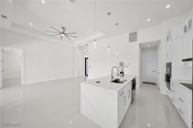 2219 Surfside Blvd, Cape Coral, FL 33991 - kitchen with a sink, a raised ceiling, white cabinetry, stainless steel dishwasher, and a ceiling fan