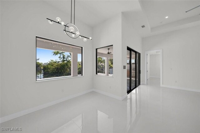 2219 Surfside Blvd, Cape Coral, FL 33991 - tiled empty room with baseboards, a chandelier, and recessed lighting