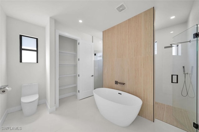 2219 Surfside Blvd, Cape Coral, FL 33991 - full bathroom featuring a stall shower, a freestanding tub, a walk in closet, toilet, and recessed lighting