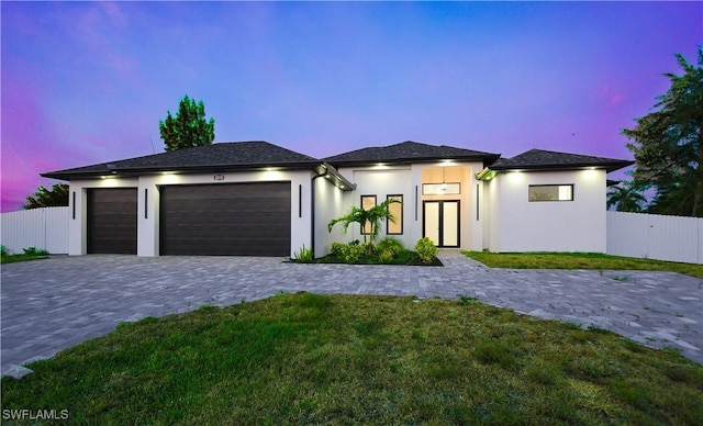 2219 Surfside Blvd, Cape Coral, FL 33991 - prairie-style home featuring a garage, decorative driveway, and stucco siding