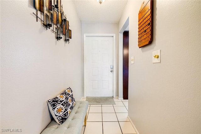6324 Sugar Bush Ln Unit F, Fort Myers, FL 33908 - doorway featuring light tile patterned floors, a textured ceiling, and baseboards