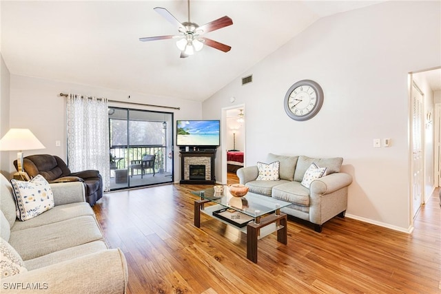 6324 Sugar Bush Ln Unit F, Fort Myers, FL 33908 - living room with ceiling fan, light wood-style floors, high vaulted ceiling, baseboards, and a stone fireplace