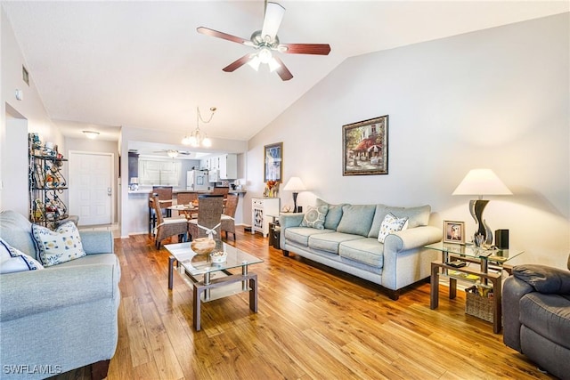 6324 Sugar Bush Ln Unit F, Fort Myers, FL 33908 - living room featuring a ceiling fan, light wood-type flooring, vaulted ceiling, and a chandelier