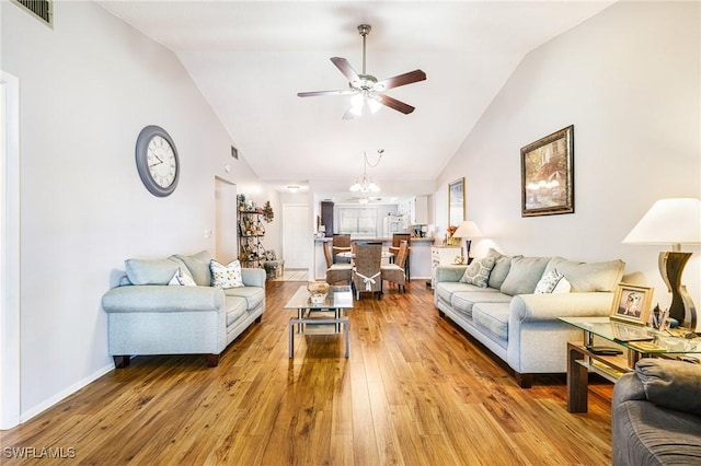 6324 Sugar Bush Ln Unit F, Fort Myers, FL 33908 - living area with a ceiling fan, hardwood / wood-style flooring, high vaulted ceiling, a chandelier, and baseboards