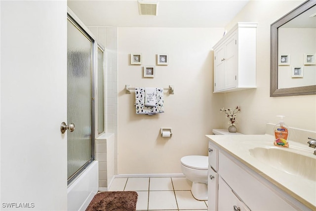 6324 Sugar Bush Ln Unit F, Fort Myers, FL 33908 - full bath with toilet, vanity, tile patterned floors, bath / shower combo with glass door, and baseboards