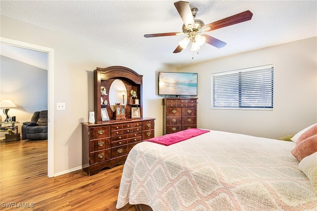 6324 Sugar Bush Ln Unit F, Fort Myers, FL 33908 - bedroom with wood finished floors, ceiling fan, a textured ceiling, and baseboards