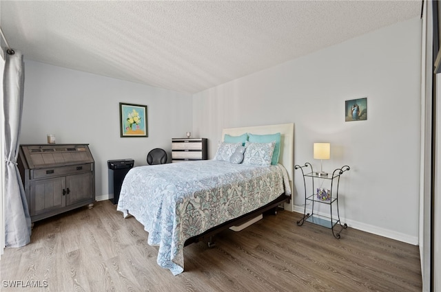 5210 Cedarbend Dr Unit 4, Fort Myers, FL 33919 - bedroom featuring wood finished floors, a textured ceiling, and baseboards
