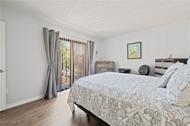 5210 Cedarbend Dr Unit 4, Fort Myers, FL 33919 - bedroom featuring access to outside, wood finished floors, a textured ceiling, and baseboards