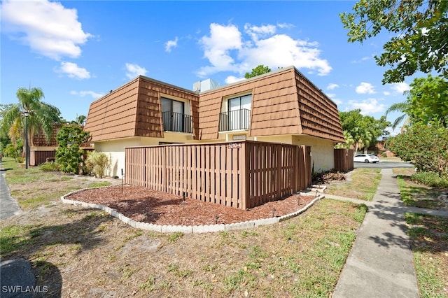 5210 Cedarbend Dr Unit 4, Fort Myers, FL 33919 - view of side of property with mansard roof and a balcony