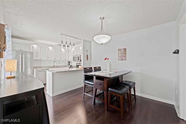 5210 Cedarbend Dr Unit 4, Fort Myers, FL 33919 - dining room with a textured ceiling, dark wood-style flooring, and baseboards