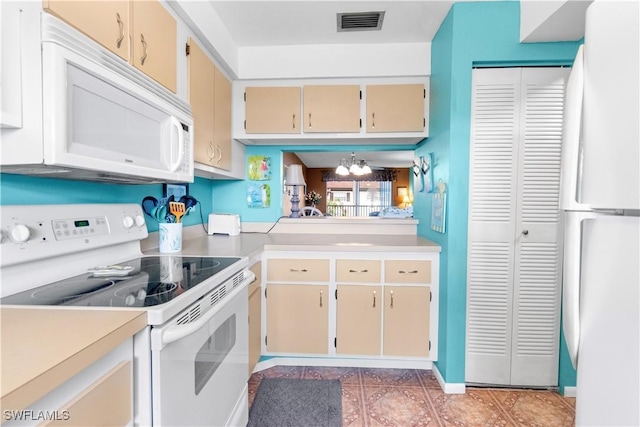 7013 New Post Dr Unit 7, North Fort Myers, FL 33917 - kitchen with white appliances, cream cabinets, light countertops, and a chandelier