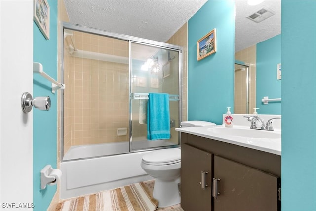 7013 New Post Dr Unit 7, North Fort Myers, FL 33917 - full bathroom featuring vanity, a textured ceiling, toilet, and bath / shower combo with glass door