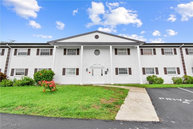 7013 New Post Dr Unit 7, North Fort Myers, FL 33917 - view of front of home featuring a front yard and uncovered parking